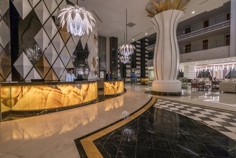 luxury hotel lobby with white, gold, and black detailing